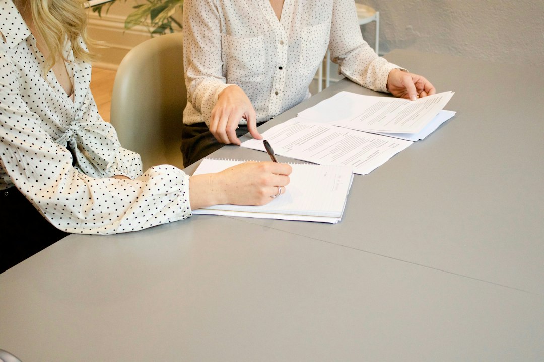 Professionisti che esaminano e sottoscrivono un accordo di coesistenza tra marchi